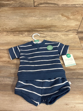 Front view of Little Planet organic navy striped shirt and matching shorts showing ribbed hem and hangtag on wood background