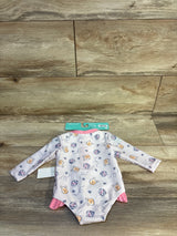 Disney Baby Winnie the Pooh long-sleeve onesie with pink trim, honey pot print, on wood floor