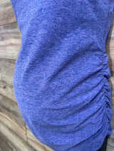 Close-up side view of purple spacedye maternity cami showing ruched side detail on a wooden background