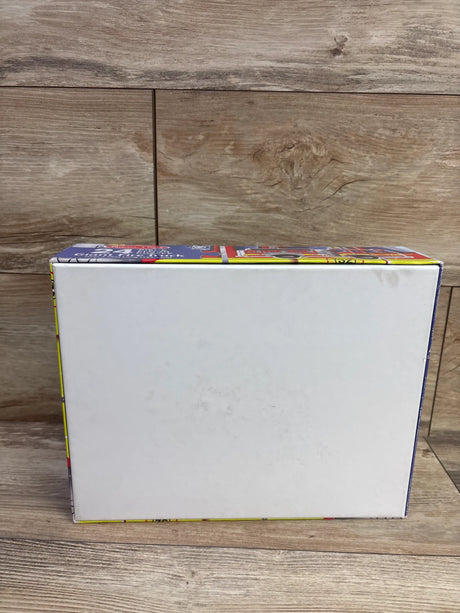 Back view of Melissa & Doug 24pc Giant Fire Truck Floor Puzzle box showing a blank white panel on a wood-patterned surface