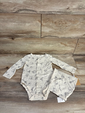 Neutral long sleeve baby bodysuit and shorts set with vegetable print on wood background