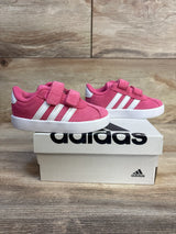 Pink Adidas toddler sneakers with velcro straps, white soles, and classic 3 stripes on box
