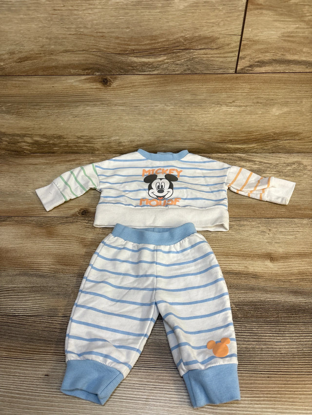 Striped baby outfit with Mickey Mouse print, long sleeve shirt and matching pants on wood floor