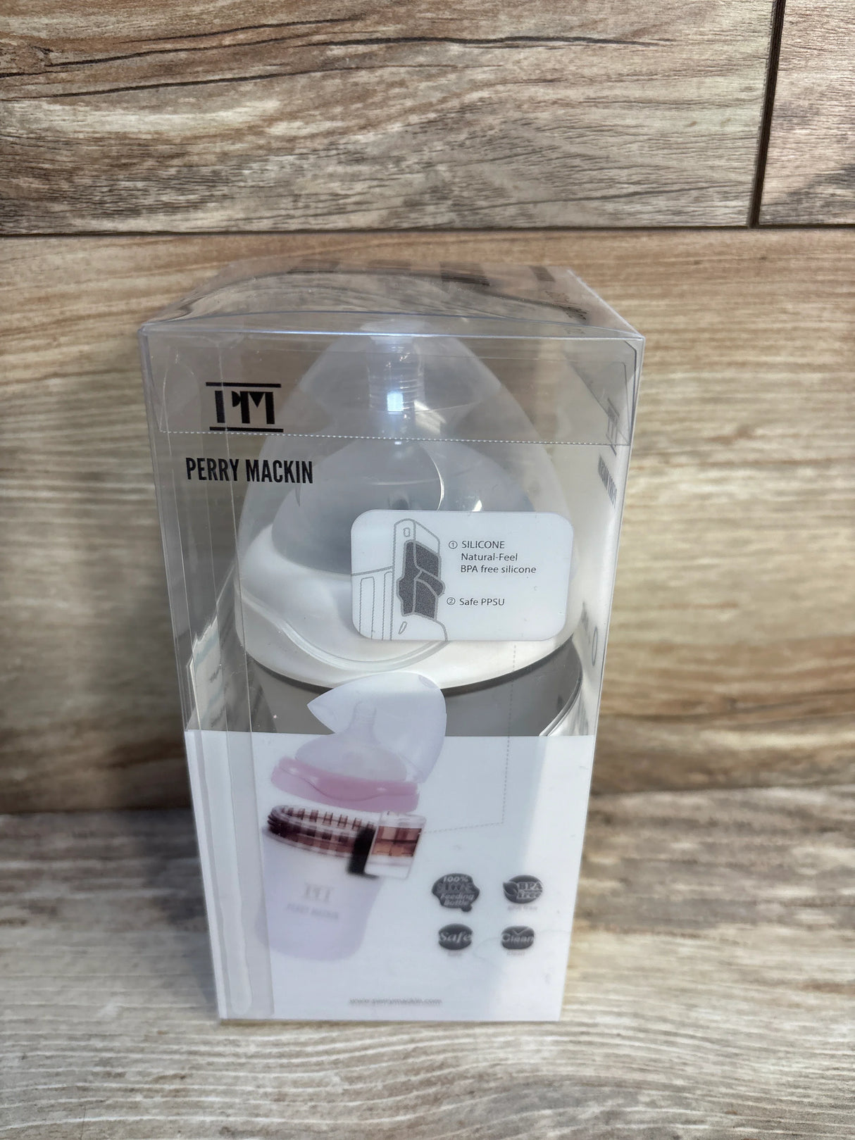 Perry Mackin silicone baby bottle in clear packaging on wood background