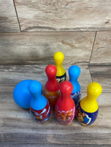 Colorful kids' bowling set with cartoon character pins and blue ball on wood surface