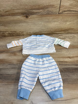 Flat-lay of Disney Baby Mickey Mouse newborn 2-piece long-sleeve shirt and joggers showing light-blue horizontal stripes, mismatched orange and green sleeves, and blue ribbed cuffs on wood background