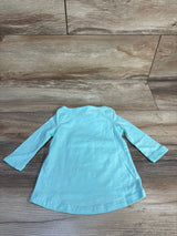 Light blue long sleeve baby dress on wood background, gently used children's clothing