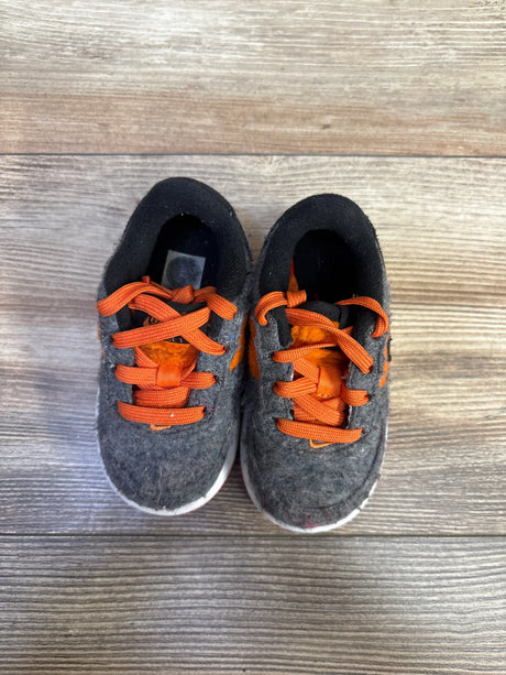 Top view of Nike toddler Force 1 LV8 TD sneakers, gray felt with orange laces and Swoosh, white soles on wood