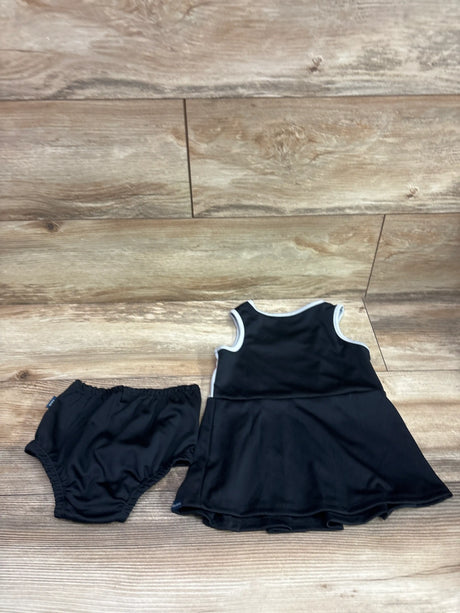 Overhead view of black Las Vegas Raiders cheer captain dress and matching bloomers showcasing white trim with a wood floor background