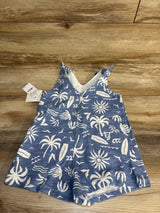 Blue toddler romper with white tropical print, palm trees, and surfboards on wood background
