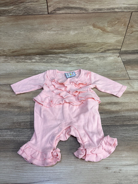 Front view of Three Sisters ruffle coverall in pink, showcasing layered ruffles and ruffled cuffs on a wood-look floor