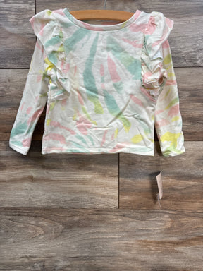 Pastel tie-dye long sleeve toddler shirt with ruffle details on shoulders on wooden floor