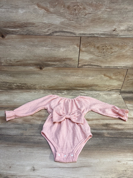 Pink textured long sleeve bubble romper for infants with a large center bow