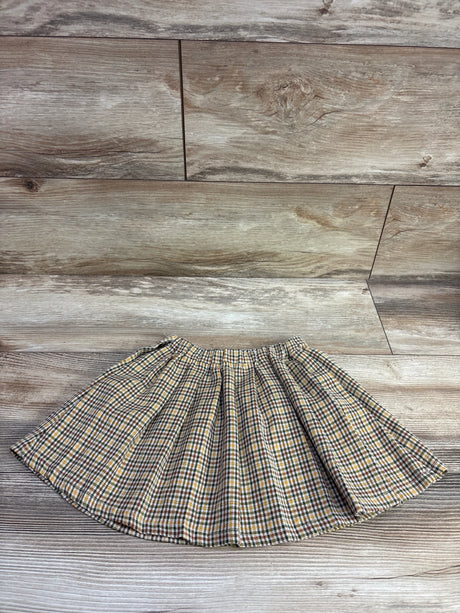 Front view of Zara yellow plaid flannel skirt, size 2-3T, showcasing elastic waistband and gathered shape on wood flooring