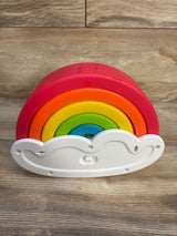 Colorful rainbow stacking toy with cloud base on wood background, baby toy, kids gift