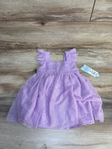 Light purple toddler dress with ruffled sleeves, displayed on wood background, resale kids clothes