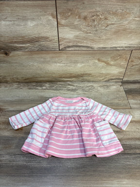 Pink and white striped long sleeve baby dress with pockets on wood floor