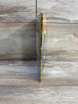 Side view of A Little Golden Book I'm a Truck hardcover showing illustrated yellow spine and slight corner wear on wood background