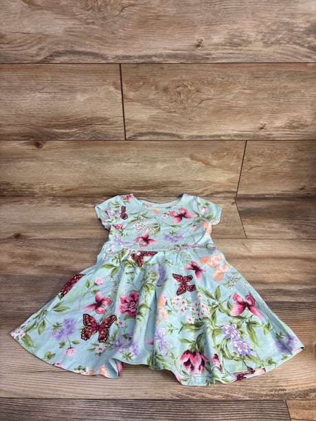 Flat lay of Children's Place blue toddler dress showing pink and purple butterfly and floral print on wood background, size 4T