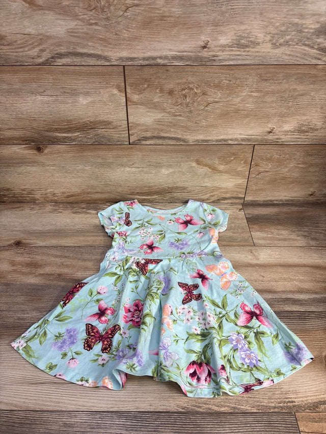 Flat lay of Children's Place blue toddler dress showing pink and purple butterfly and floral print on wood background, size 4T