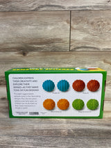 Rear view of Lakeshore Mix and Match Sensory Spheres box showing four pairs of textured spheres on a wood surface