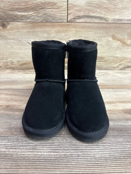 Pair of black BearPaw Eliza boots for kids, size 8c, on a wooden background.