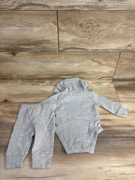 Gray long-sleeve hooded baby onesie with matching pants laid flat on wood floor