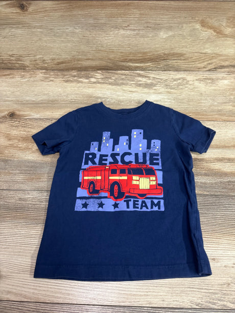 Front view of blue Carter’s Rescue Team shirt, size 3T, with red fire truck and RESCUE TEAM graphic on wood background
