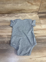 Flat lay of grey Sprout Joy Lil Nugget baby bodysuit showing short sleeves and heather knit on wood background