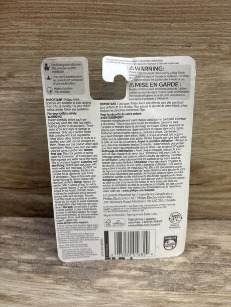 Back view of Philips Avent 2-pack Soothie pacifier packaging showcasing medical-grade silicone and one-piece construction on a wood surface