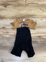 Flat lay of two-piece baby set brown cropped motorcycle tee and black ribbed romper with snap crotch on wood background