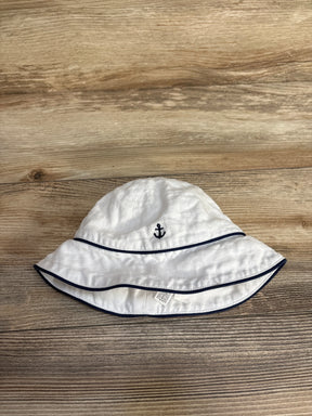 White baby bucket hat with navy blue anchor embroidery and trim on wooden surface