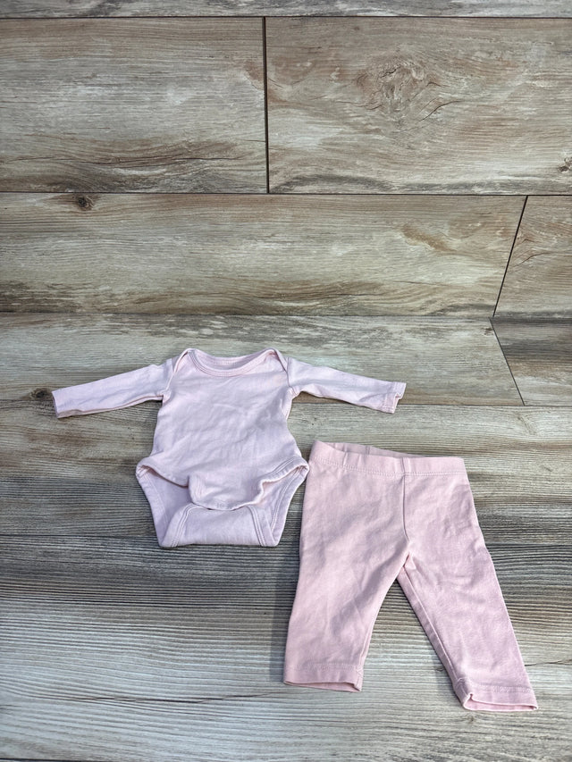 Flat lay of H&M preemie pink long-sleeve bodysuit and matching pants showing snaps and elastic waist on wood background