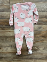 Pink footed baby sleeper with white sheep print on wood floor
