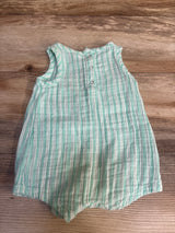 Mint green and white striped sleeveless baby romper with buttons on wood background