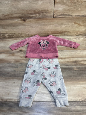 Pink Minnie Mouse toddler sweater and matching gray jogger pants set on wooden floor