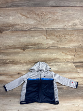 Champion kids hooded zip-up jacket in grey and navy blue with blue stripe on wooden background