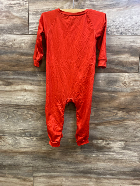 Front view of a red long-sleeve baby coverall showing cuffed sleeves and legs against a wood backdrop