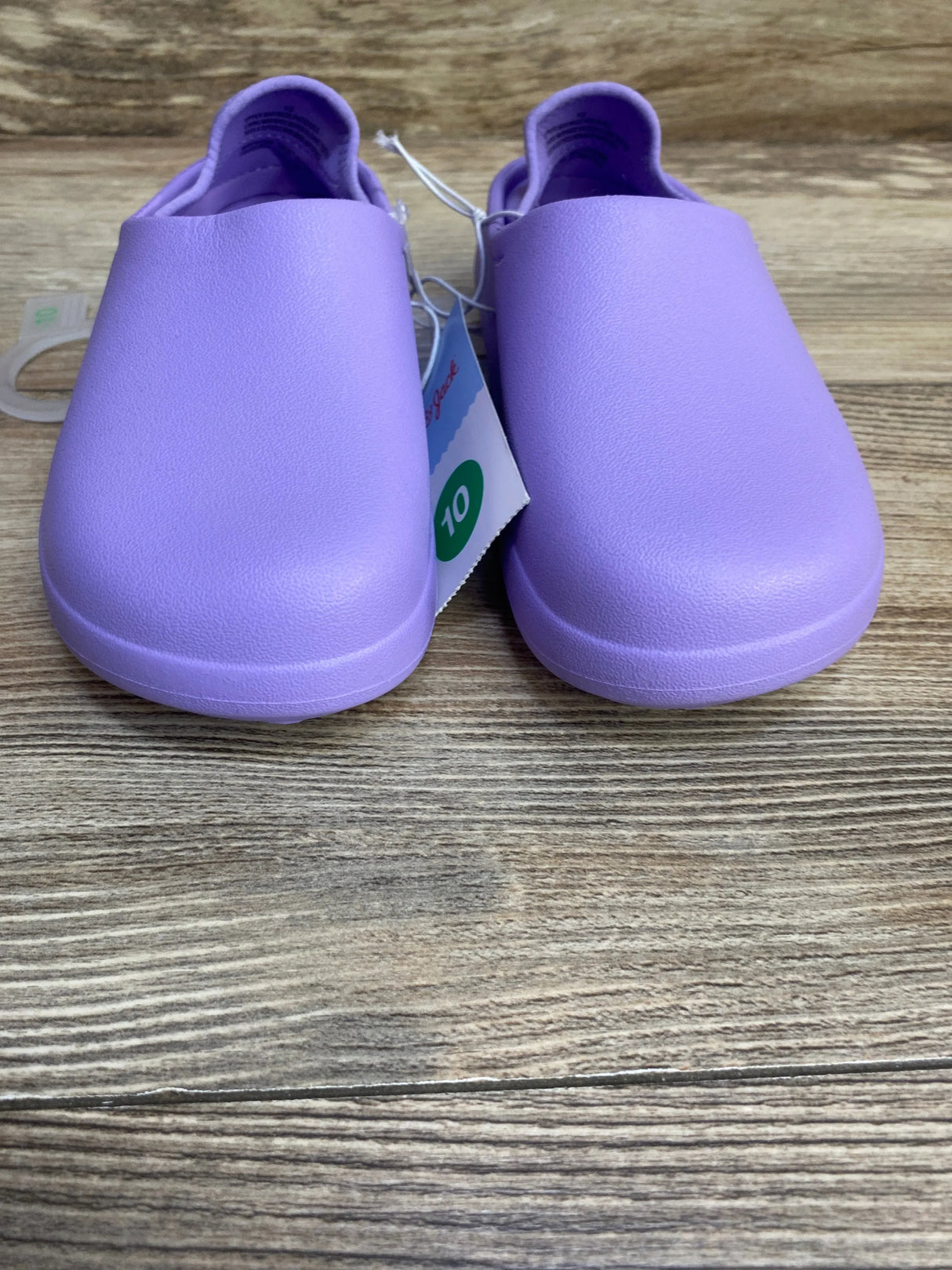Front view of Cat and Jack purple toddler water shoes size 10C showing rounded toe and slip-on design on wood floor