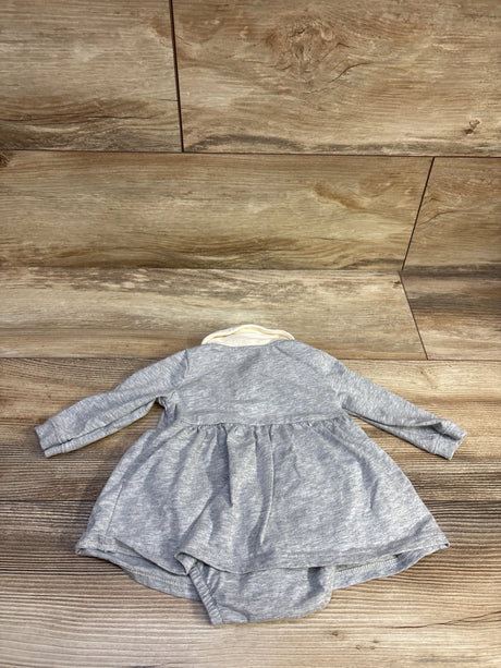 Front view of Carter’s grey polo bodysuit dress showcasing long sleeves, attached bloomers, and white collar on a wood-look floor