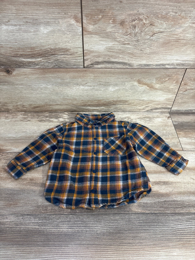 Toddler's long-sleeve flannel shirt in navy, orange, and white plaid on wood floor