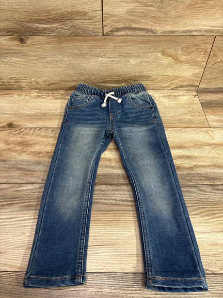 Cat & Jack blue drawstring skinny jeans for toddlers on a wooden background