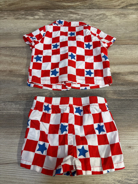 Top view of Cat and Jack two-piece shirt and shorts showing red and white checkered pattern with blue stars on wood background