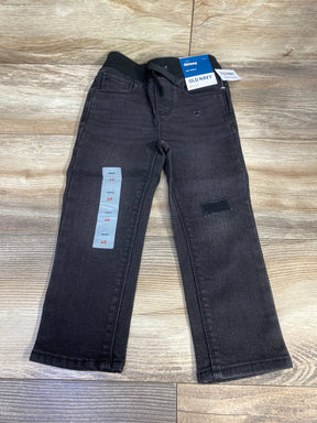 Black skinny toddler jeans, size 2T, with elastic waistband on wood floor