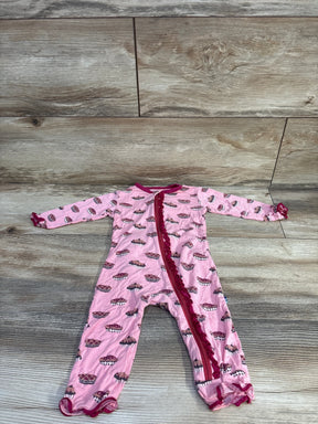Flat lay of Kickee Pants bamboo ruffle zip coverall in pink with cupcake print, ruffle zipper and ruffled cuffs on wood floor
