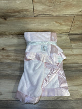 Top-down view of Little Giraffe Luxe baby blanket folded to show pink plush fabric and satin ribbon trim on a wood background