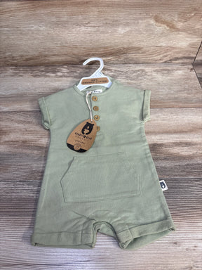 Front view of green Rabbit and Bear organic henley shortie romper showing three wooden buttons, kangaroo pocket, and brand tag on wood background