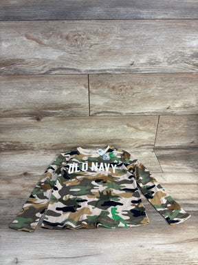 Flat lay of Old Navy boys camouflage waffle-knit long-sleeve shirt showing front OLD NAVY logo and visible 5T tag on wood floor