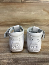 White baby shoes with Incredibles logo, soft sole, velcro strap, perfect for infants and toddlers.