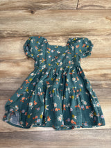 Green floral puff sleeve toddler dress on wooden floor, kids clothing resale item
